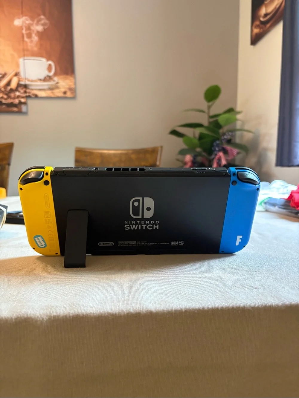 Nintendo Switch with Blue Left and Yellow Right Joy‑Con Controllers